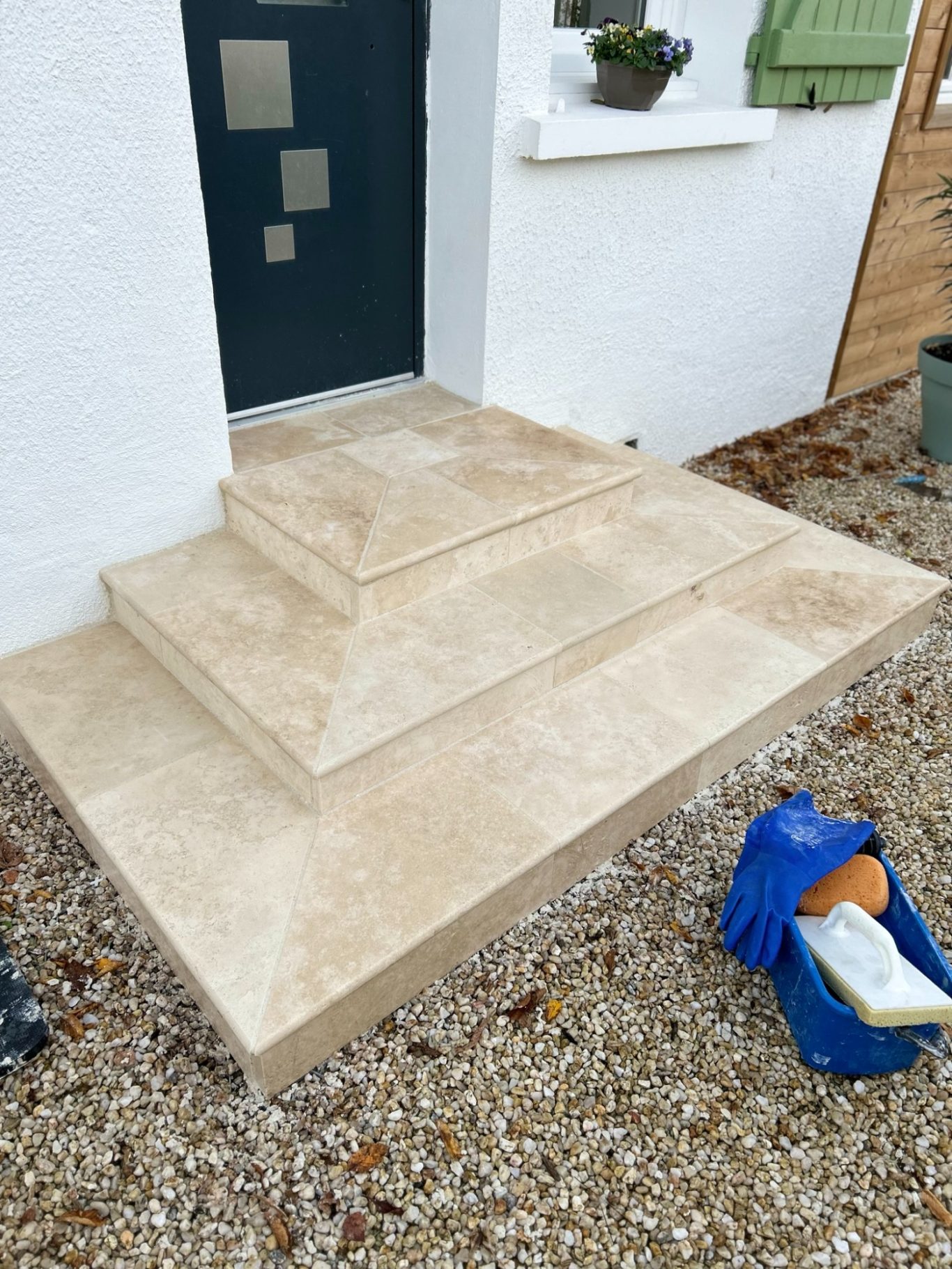 Escalier en travertin Escalier en pierre avec plusieurs marches, petit sac à côté sur le sol.